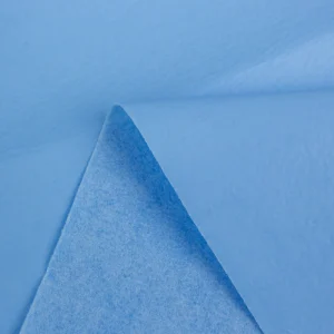 Blue PE Film Composite Spunlace Nonwoven Fabric Roll Lightweight Thickness for Surgical Gowns and Pads